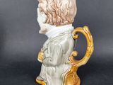 a ceramic figurine of a man wearing a suit and tie