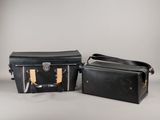 two pieces of luggage sitting next to each other on a table