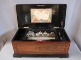 a wooden box that has a musical box inside of it