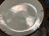 a white plate sitting on top of a wooden table