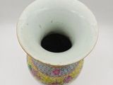 a white vase with a colorful design on it