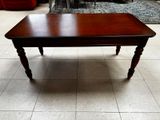 a coffee table with a wooden top on a tile floor