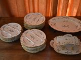 many plates and bowls sitting on a wooden table