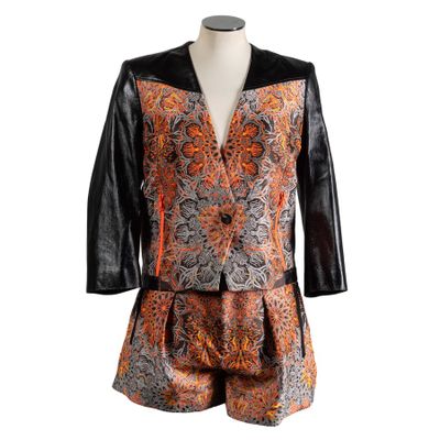 an orange and black jacket and shorts are on a mannequin mannequin mannequin mannequin mannequin mannequin mannequin mann