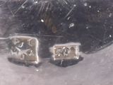 a close up of a pair of earrings on a table