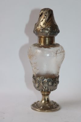 a glass bottle with a bird on top of it