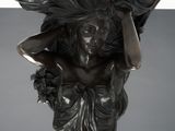 an image of a sculpture of a woman holding a basket on her head