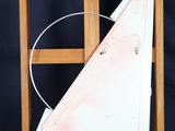 painting of a sailboat on a wooden easel against a black background
