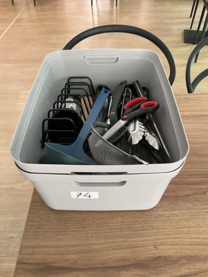 a white container with scissors and other office supplies in it