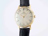 a close up of a watch on a black strap on a white background