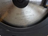 a close up of a metal disc on a table