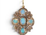 an oplite and diamond broochle pendant on a white background
