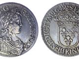 une pièce d'argent surmontée d'une couronne