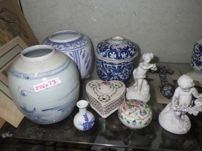 many vases and figurines sitting on a glass table