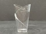 a glass vase with a piece of paper in it on a table