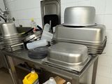 many pans and pans sitting on a table in a kitchen