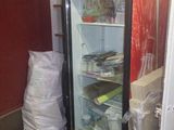 a coca cola cooler sitting in the corner of a room
