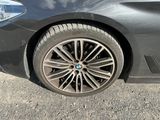 a close up of a car ' s tire on the road