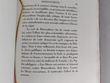 an open book on a table with an orange string around it