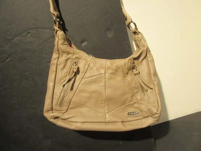 beige leather purse with zippers and zippers hanging from it