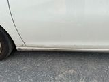 a picture of a white car parked in a parking lot