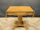 a wooden table with a small drawer on top of it
