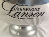 a large silver vase with a black label on it