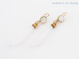 a pair of earrings with clear quartz and gold