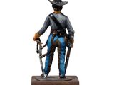 statue of a man in a cowboy outfit holding a gun