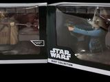 two star wars action figures are in a box on a black background