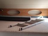 a bed with a ladder in the middle of it