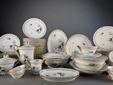 many plates and bowls that are sitting on a table