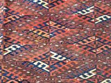 a red and blue rug with a pattern on it