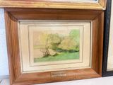 two framed paintings of trees and a river in a wood frame