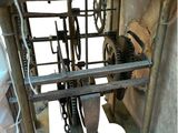 a clock that is on a stand with chains on it