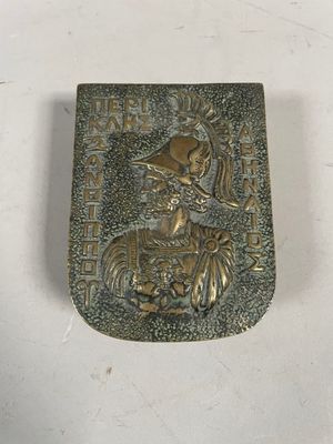 an old metal belt buckle with a picture of a woman on a horse