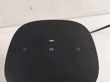 an image of a black and silver speaker sitting on top of a table
