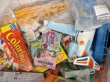 a pile of toys in a plastic bag on the floor