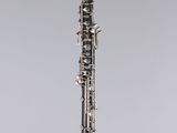 a close up of a clarinet on a clear stand