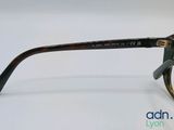 a close up of a pair of glasses on a white surface