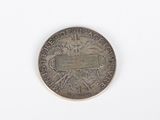an old coin on a white surface with a white background