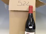 a bottle of wine sitting next to a cardboard box
