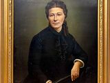 portrait of a woman in a black dress holding a cane