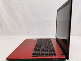 an open red laptop computer sitting on top of a white table