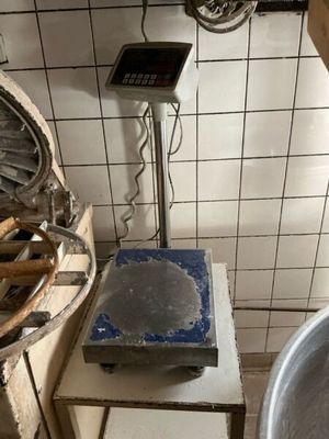 a large metal bowl sitting on a table in a kitchen