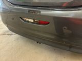 a car that is parked in a garage with a sticker on the back of it