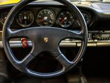 a steering wheel and dashboard of a yellow sports car