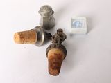 three wine corks sitting on a table next to a bottle