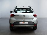 the rear end of a silver car in a white room