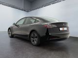 the tesla model s is parked in a large room